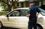 Policeman pulling over a motorist on the street.